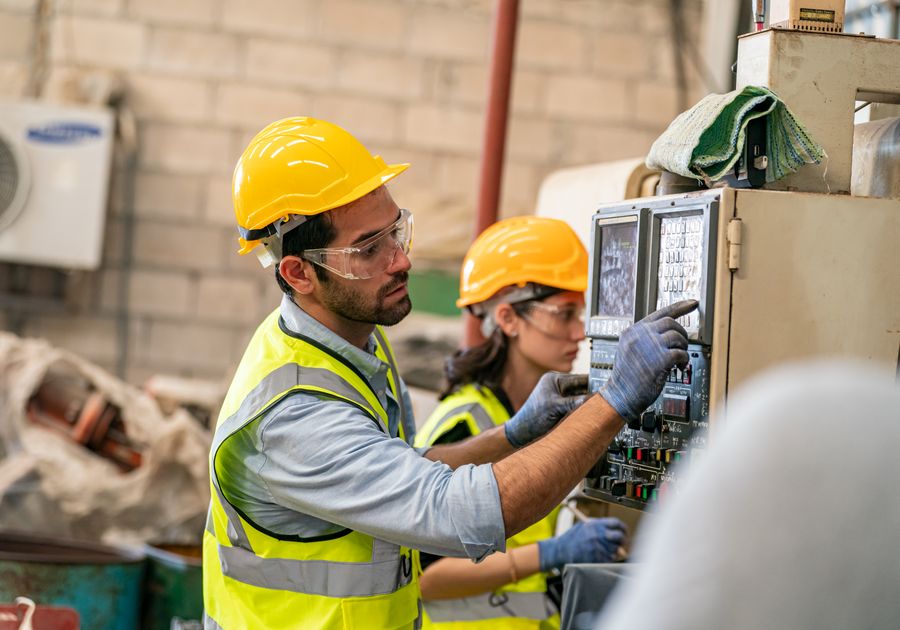 Electricians working on a control panel