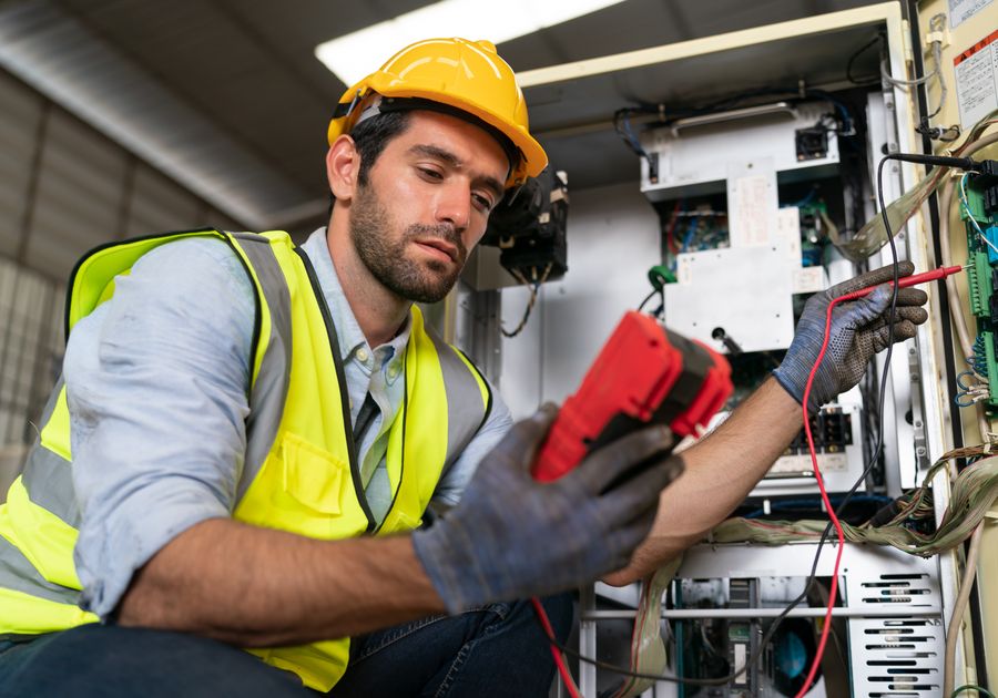 Electrician testing wiring with a multimeter