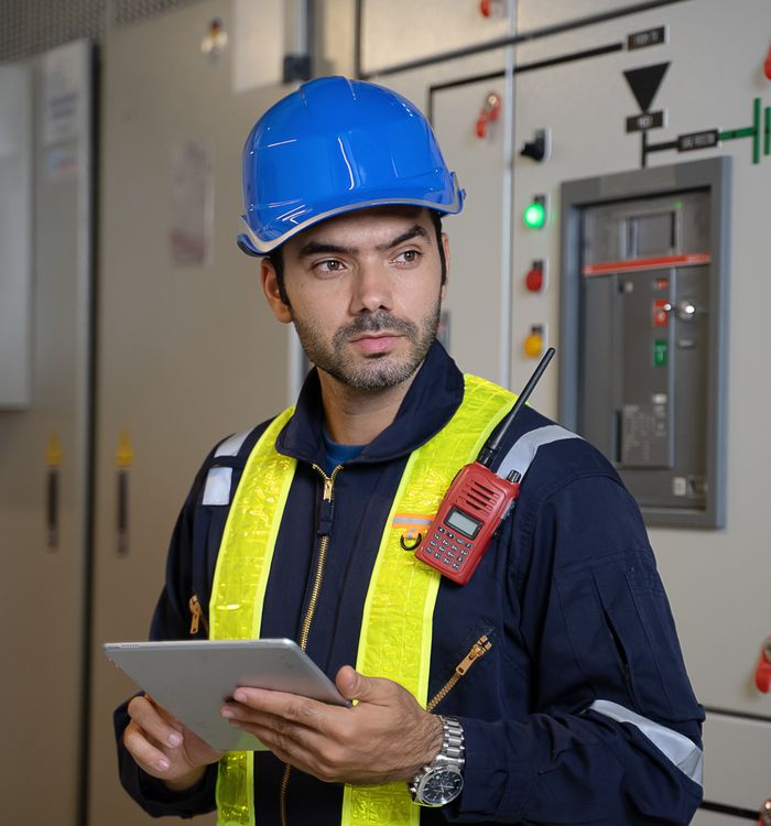 Team member with a tablet in a switch room